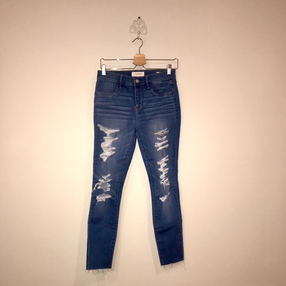 Ripped jeans with raw fringe bottom